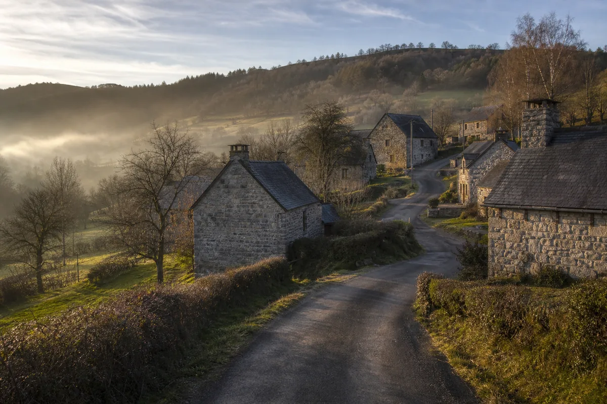 Hameau creusois aux murs de granit sous la lumière rasante de fin de journée